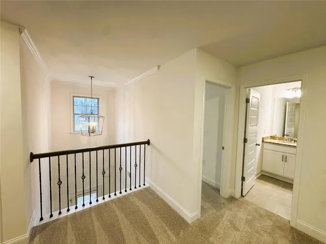 a view of a hallway with a bathroom