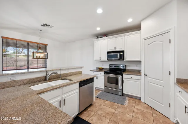 a view of kitchen with refrigerator and window