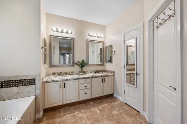 a spacious bedroom with a bed and a chandelier