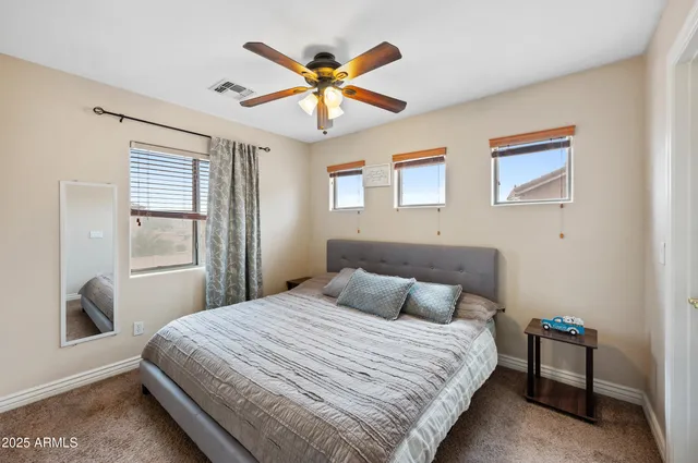 a en suite bathroom with a double vanity sink and a mirror