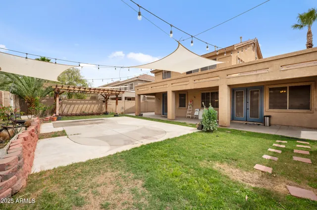 a bedroom with a large bed and a ceiling fan