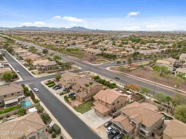 an aerial view of residential houses with outdoor space and ocean view