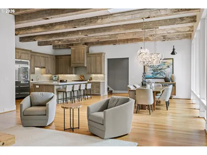 a living room with furniture and a kitchen view