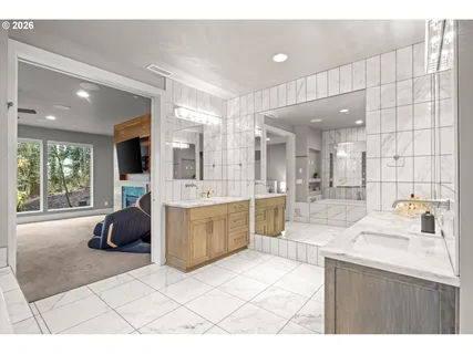 a large bathroom with a double vanity sink a mirror and a shower