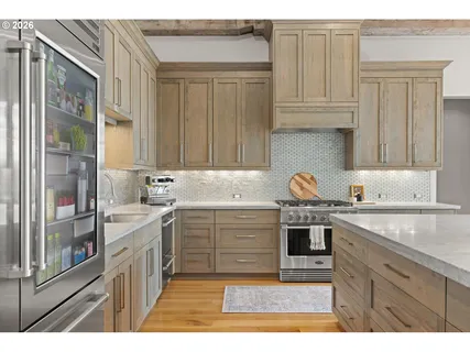 a kitchen with stainless steel appliances granite countertop a sink stove and cabinets