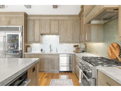 a kitchen with a sink stove and cabinets