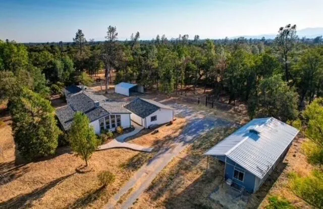 a view of a patio with table and chairs and potted plants