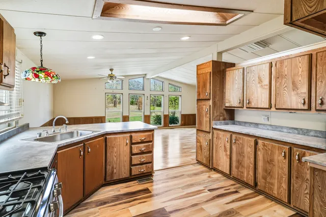 a kitchen with a sink and large windows
