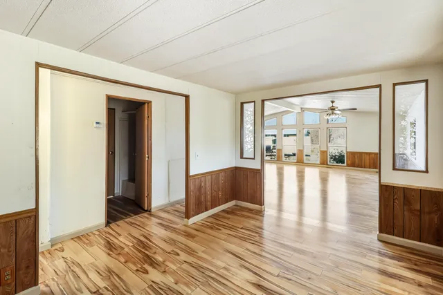 a bedroom with wooden floor and entrance