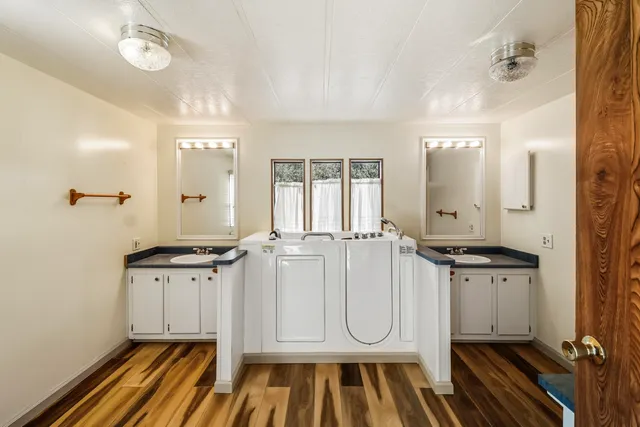 a bathroom with a sink a mirror and a shower