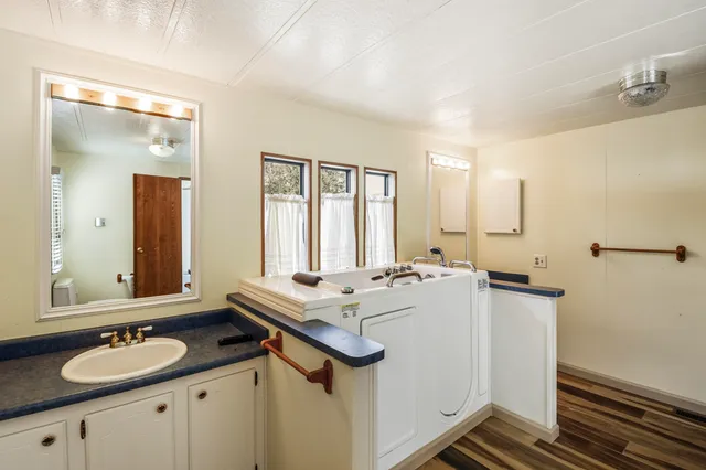 a bathroom with a sink double vanity granite and a mirror