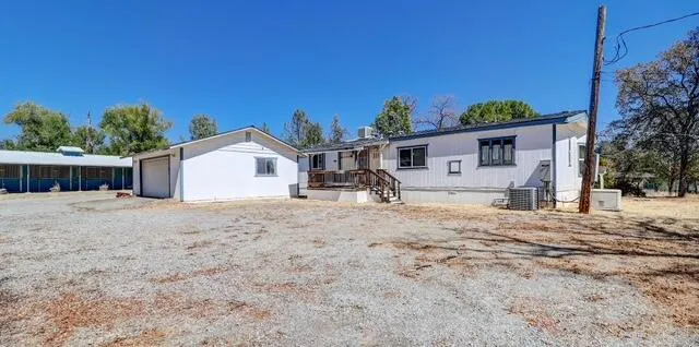 a view of a house with a yard and garage