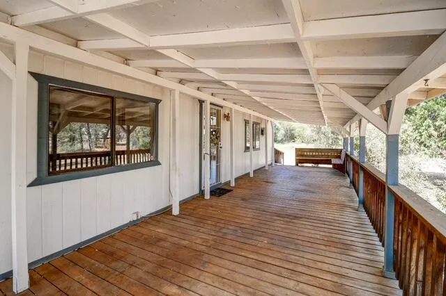 a view of a porch with wooden floor and windows