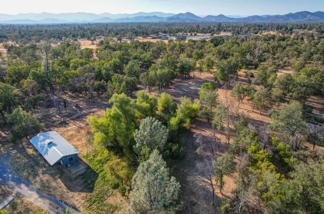 an aerial view of residential house and sandy dunes