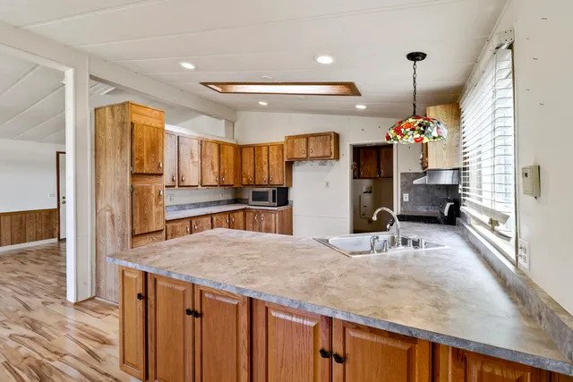 a kitchen with refrigerator and window
