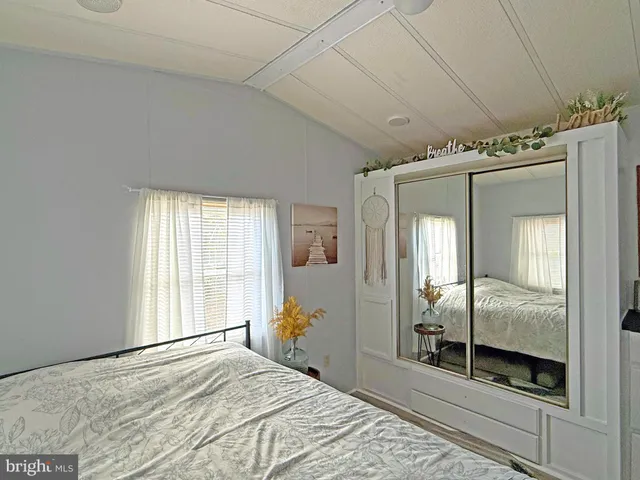 a bedroom with a bed and a mirror