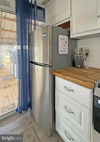 a white refrigerator freezer sitting inside of a kitchen