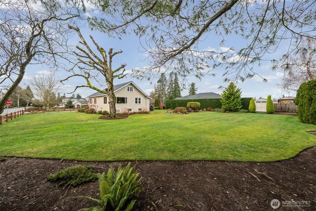 a view of yard with swimming pool and green space