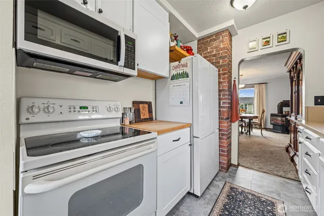 a view of a dining room with furniture and a chandelier