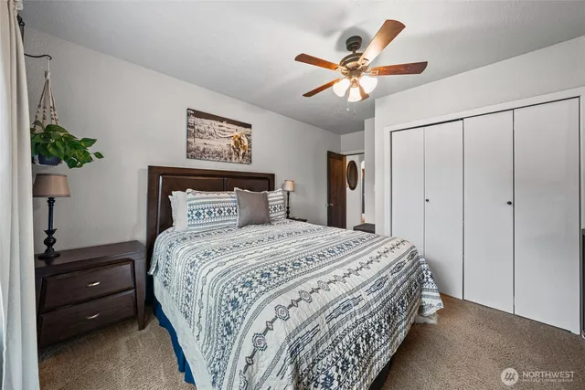 a bathroom with a granite countertop double vanity sink and mirror