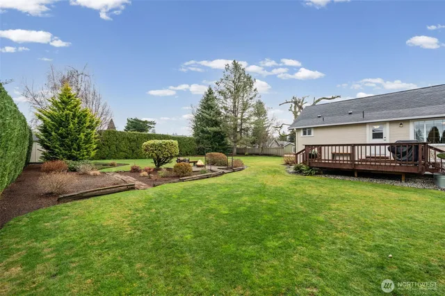 a view of a house with backyard and sitting area