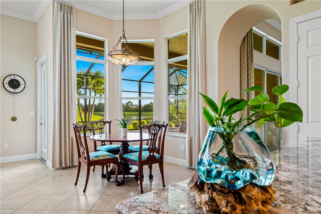 8250 Halbert Lane Vero Beach, FL 32968 - Photo 17 of 36 a dining room filled with furniture and potted plants