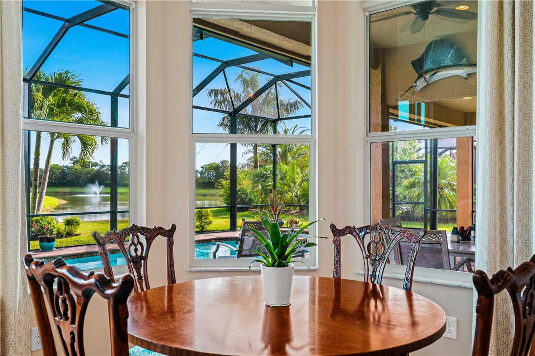8250 Halbert Lane Vero Beach, FL 32968 - Photo 18 of 36 a dining room with wooden floor table and chairs