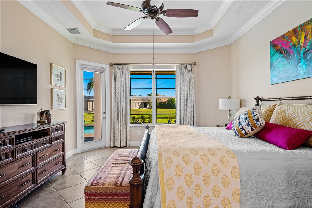 8250 Halbert Lane Vero Beach, FL 32968 - Photo 19 of 36 a bedroom with a bed and flat screen tv