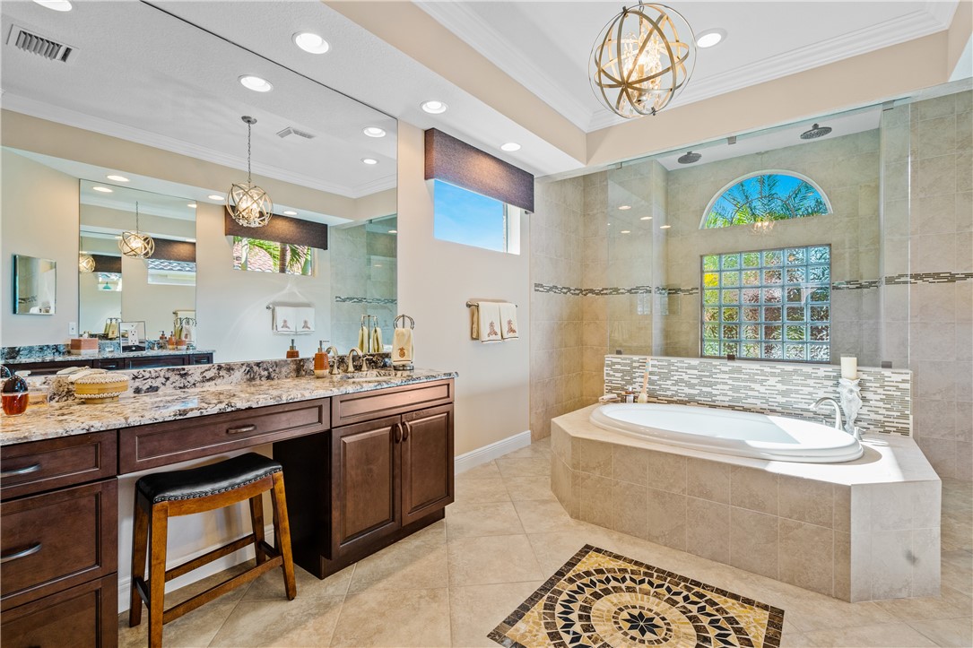 8250 Halbert Lane Vero Beach, FL 32968 - Photo 22 of 36 a spacious bathroom with a sink a large mirror and a bathtub