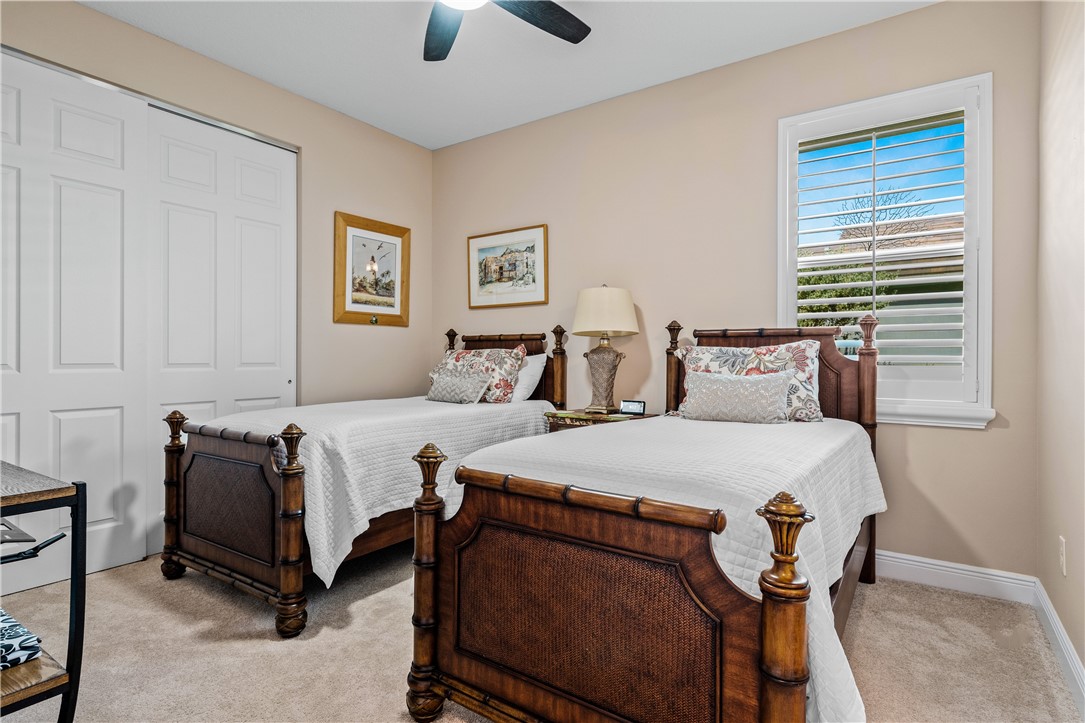 8250 Halbert Lane Vero Beach, FL 32968 - Photo 23 of 36 a bedroom with two beds and painting on the wall