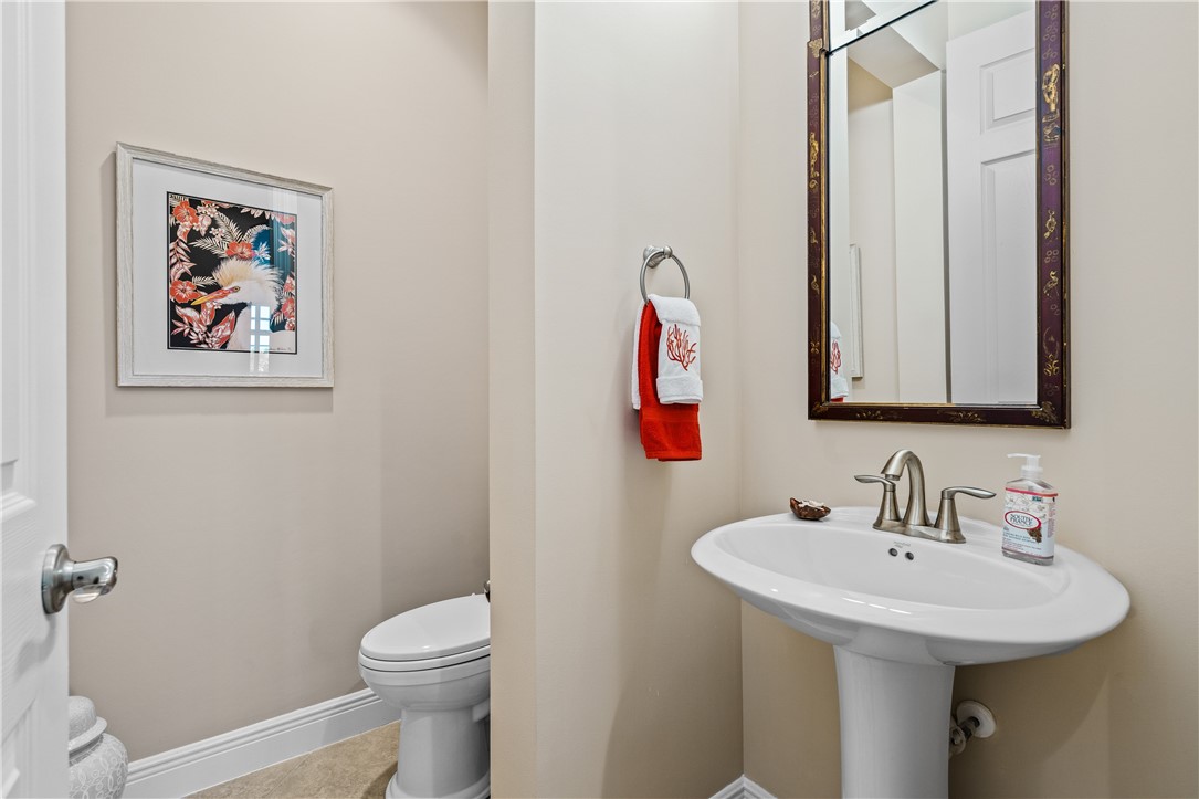 8250 Halbert Lane Vero Beach, FL 32968 - Photo 26 of 36 a bathroom with a sink and a mirror