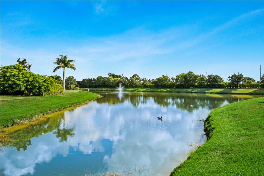 8250 Halbert Lane Vero Beach, FL 32968 - Photo 32 of 36 a view of a lake with a yard and large trees