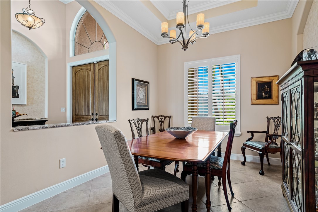 8250 Halbert Lane Vero Beach, FL 32968 - Photo 5 of 36 a view of a dining room with furniture and a chandelier