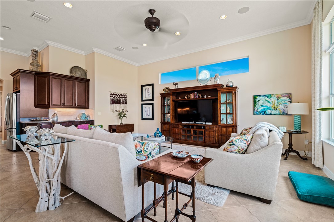 8250 Halbert Lane Vero Beach, FL 32968 - Photo 8 of 36 a living room with furniture a flat screen tv and a table