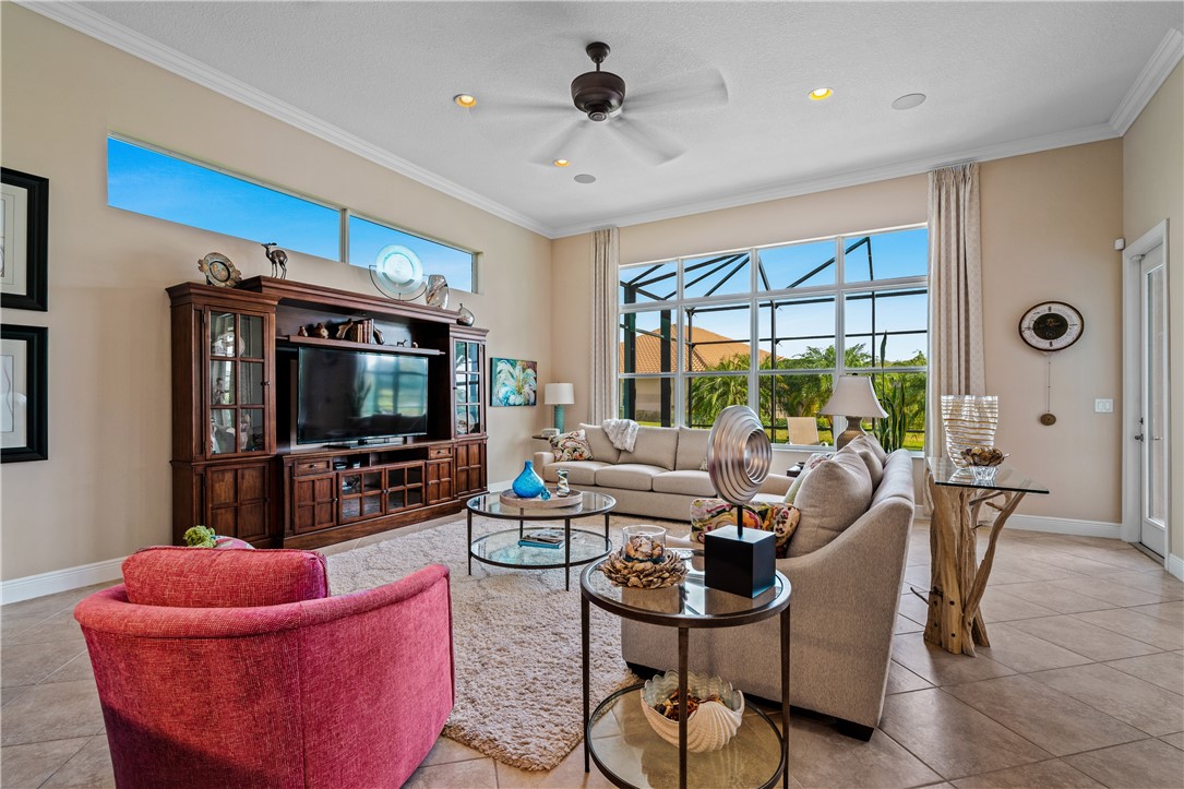 8250 Halbert Lane Vero Beach, FL 32968 - Photo 10 of 36 a living room with furniture a flat screen tv and a large window