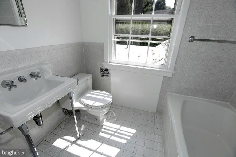5039 Overlook Road Northwest Washington, DC 20016 - Photo 23 of 27 a bathroom with a sink a toilet and a window