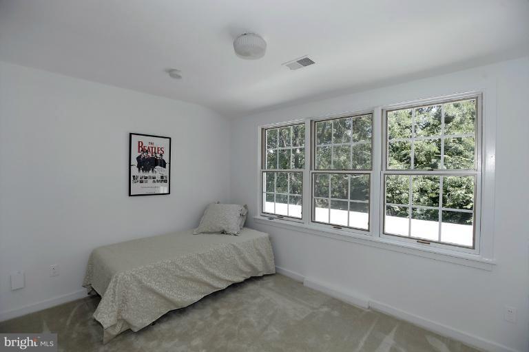 5039 Overlook Road Northwest Washington, DC 20016 - Photo 7 of 27 a bedroom with a bed and a large window
