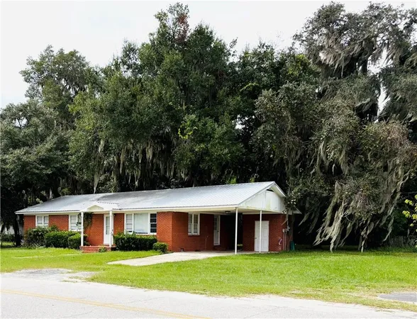 a view of house that has a tree in front of it