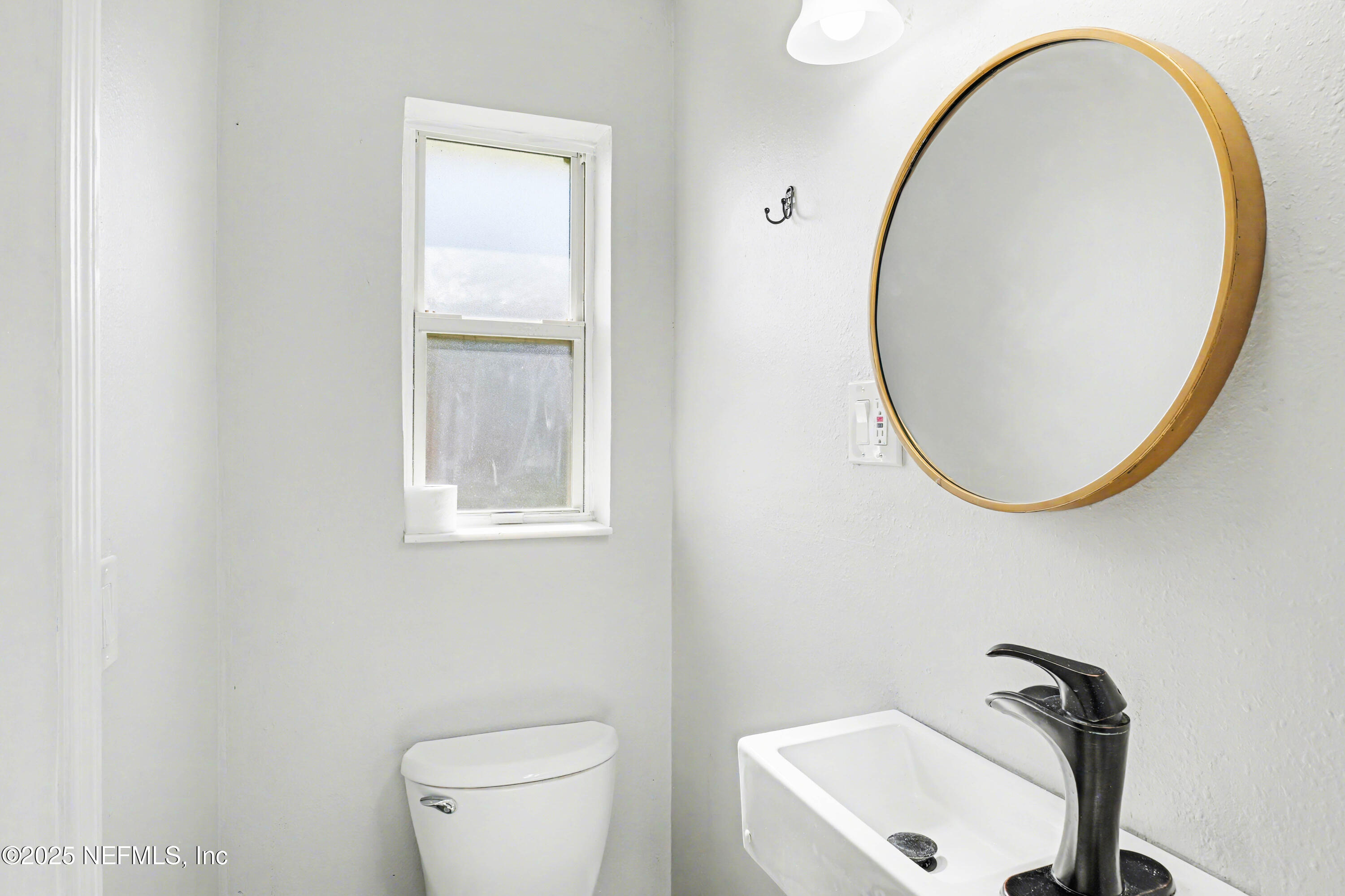 10640 Hemming Road Jacksonville, FL 32225 - Photo 14 of 46 a bathroom with a sink and a mirror