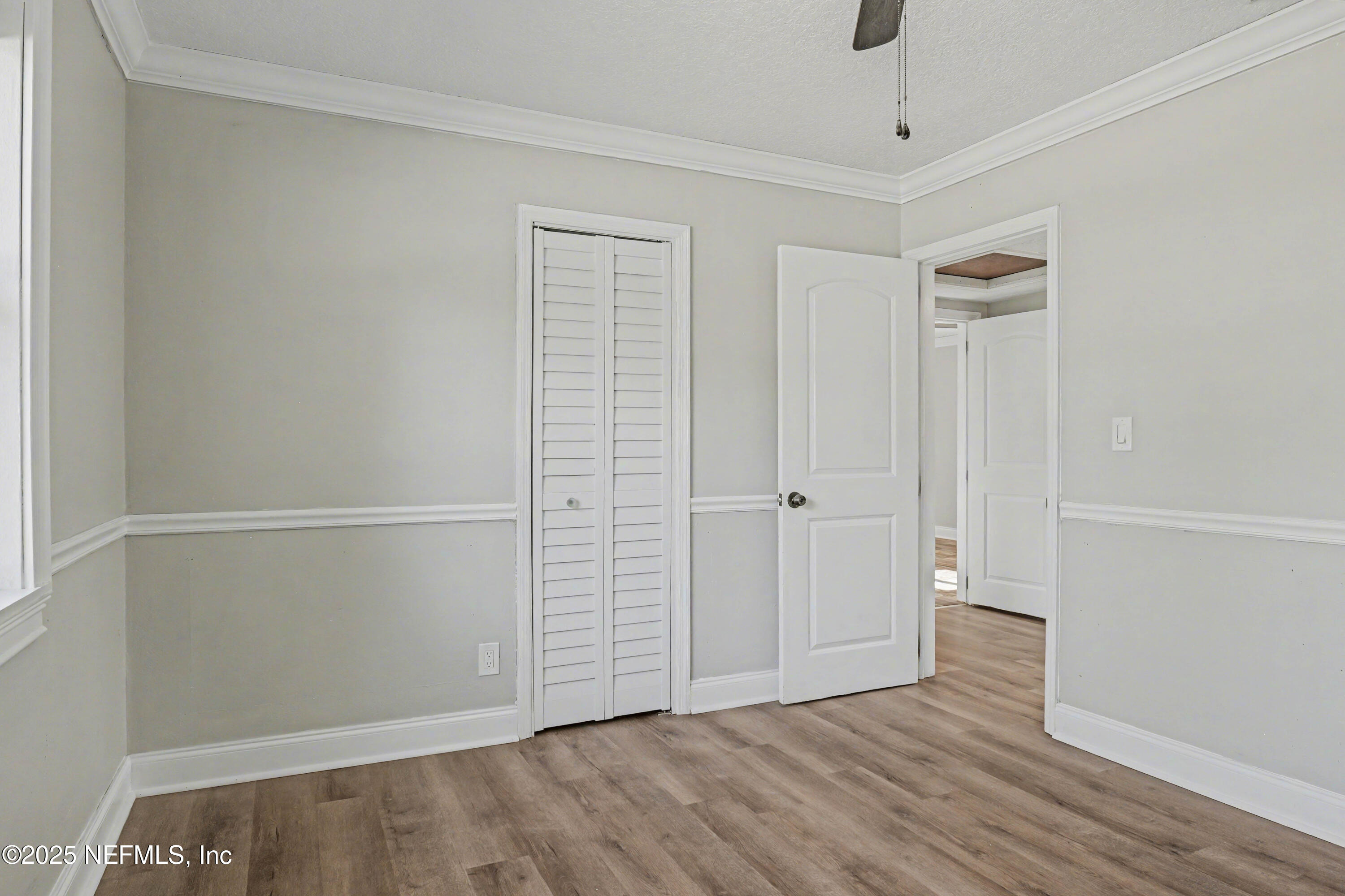 10640 Hemming Road Jacksonville, FL 32225 - Photo 21 of 46 an empty room with wooden floor and windows