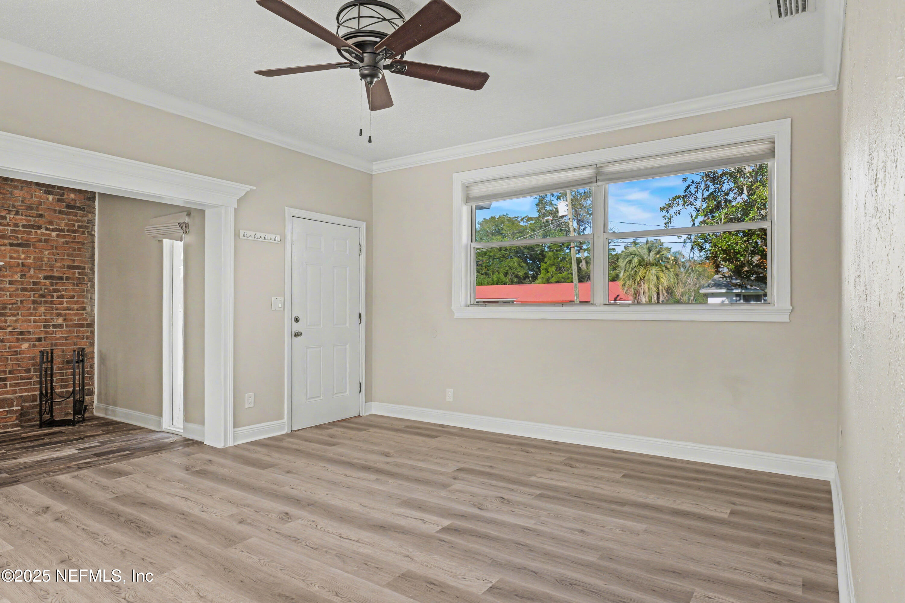 10640 Hemming Road Jacksonville, FL 32225 - Photo 38 of 46 an empty room with wooden floor fan and windows