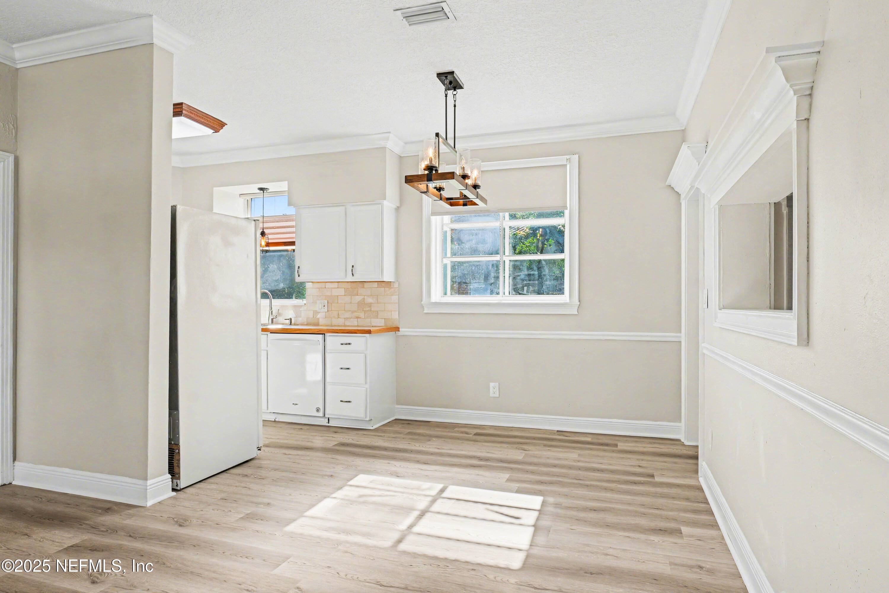 10640 Hemming Road Jacksonville, FL 32225 - Photo 40 of 46 a view of a room with a window and a refrigerator