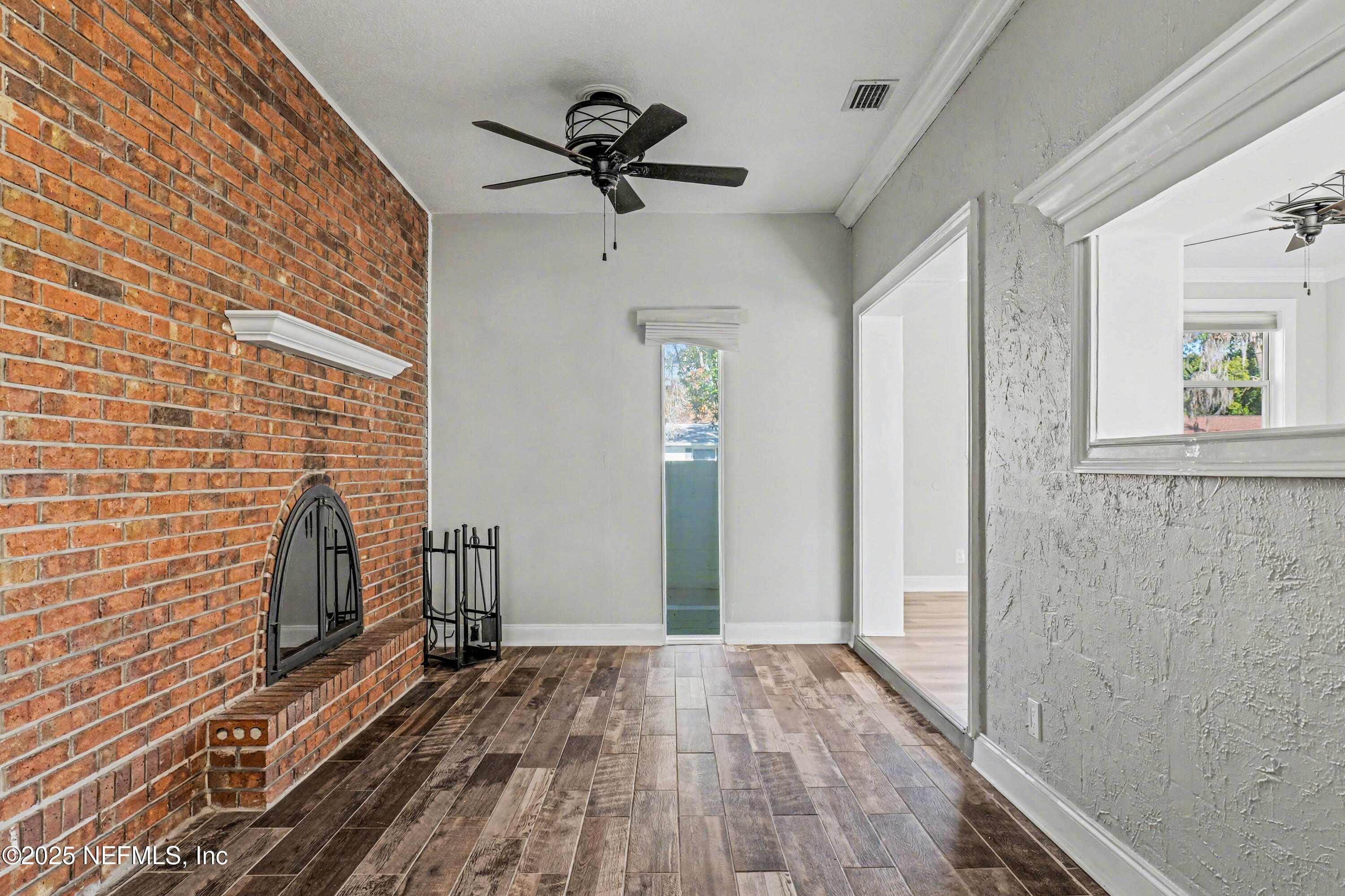 10640 Hemming Road Jacksonville, FL 32225 - Photo 6 of 46 a view of empty room with wooden floor and fan