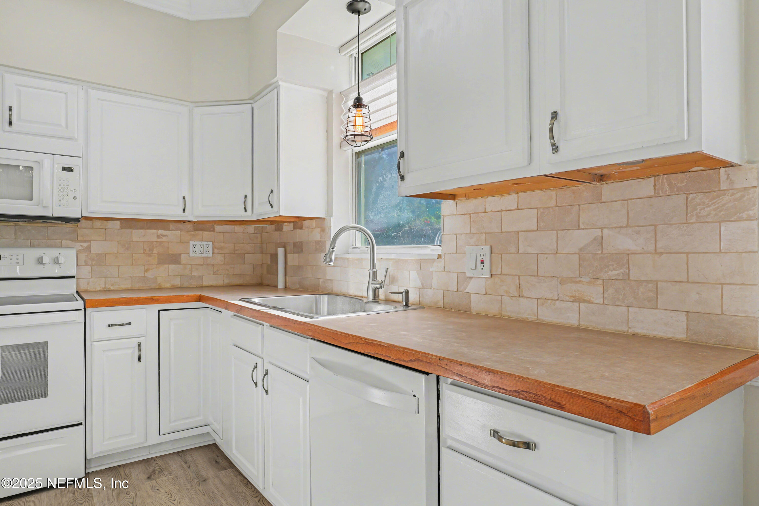 10640 Hemming Road Jacksonville, FL 32225 - Photo 7 of 46 a kitchen with a sink cabinets and window