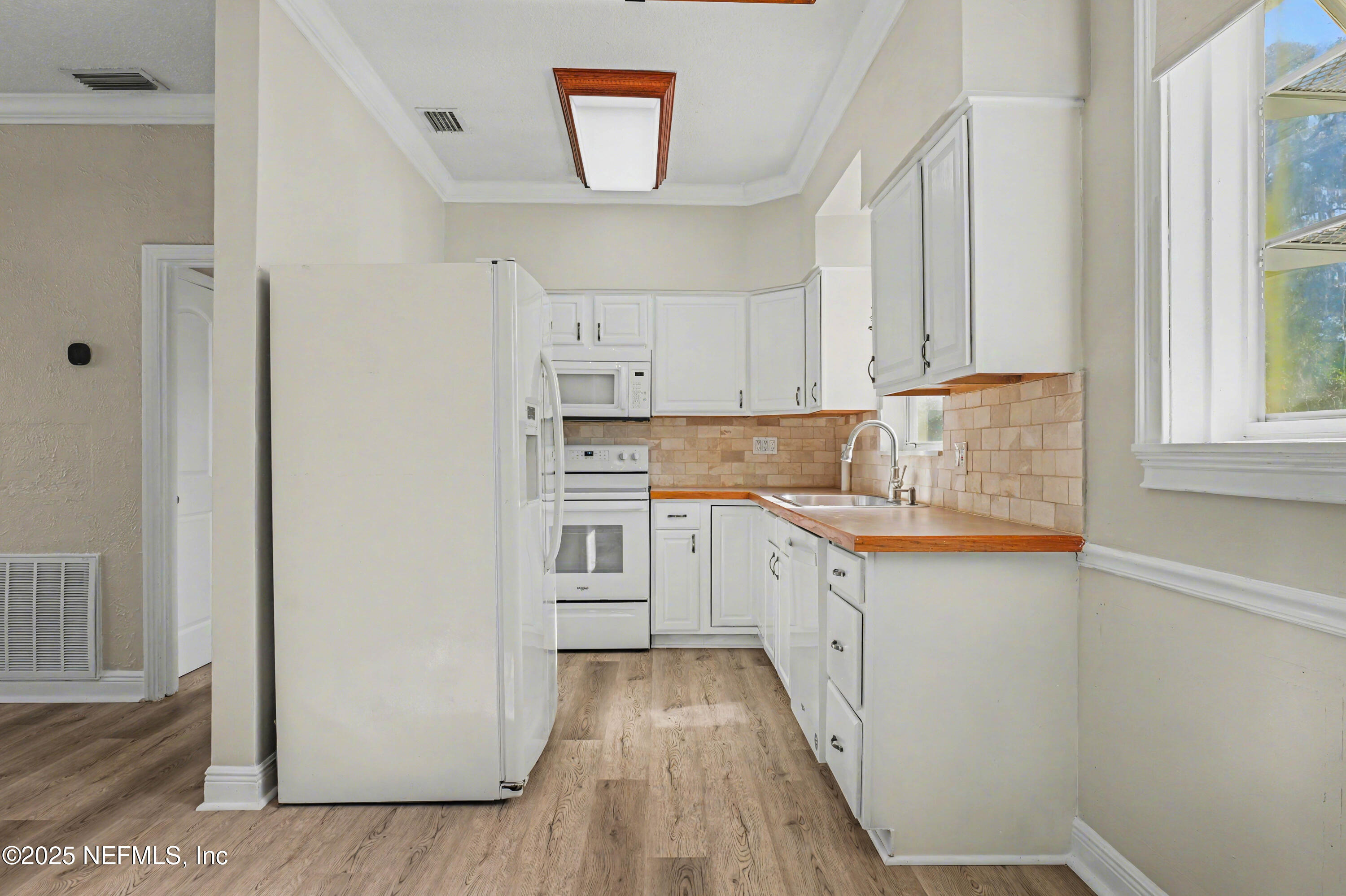 10640 Hemming Road Jacksonville, FL 32225 - Photo 9 of 46 a kitchen with white cabinets and white appliances