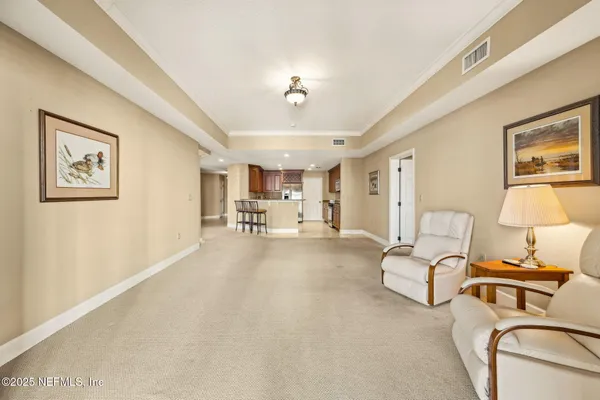 a kitchen with stainless steel appliances kitchen island granite countertop a stove a sink a refrigerator white cabinets with chairs and granite countertops