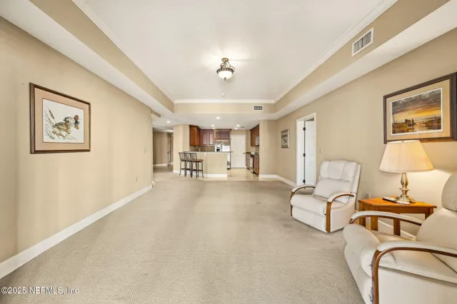 a kitchen with stainless steel appliances kitchen island granite countertop a stove a sink a refrigerator white cabinets with chairs and granite countertops