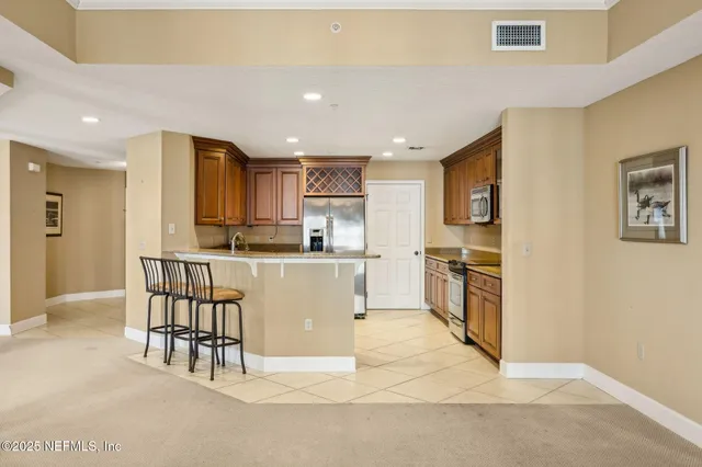 a spacious bedroom with a bed and a chandelier