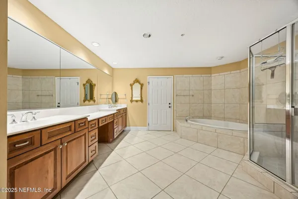a view of a room with a sink and mirror