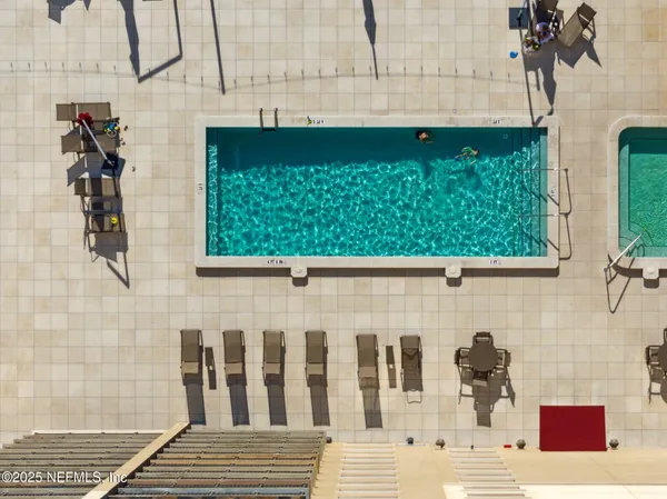 a kitchen with granite countertop a refrigerator and a stove top oven